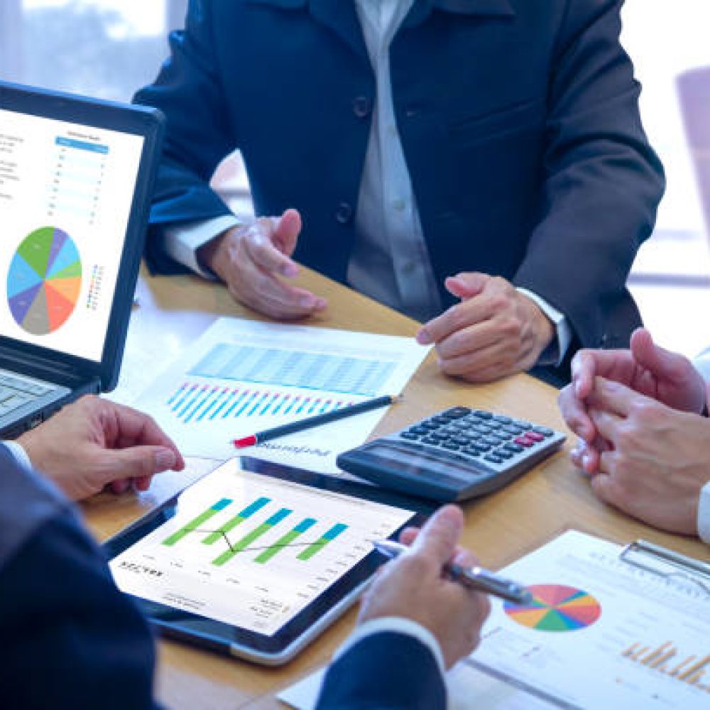 Businessmen tab on tablet touch screen to deeply reviewing a diagram or chart and financial reports for a return on investment or investment risk analysis or business performance.